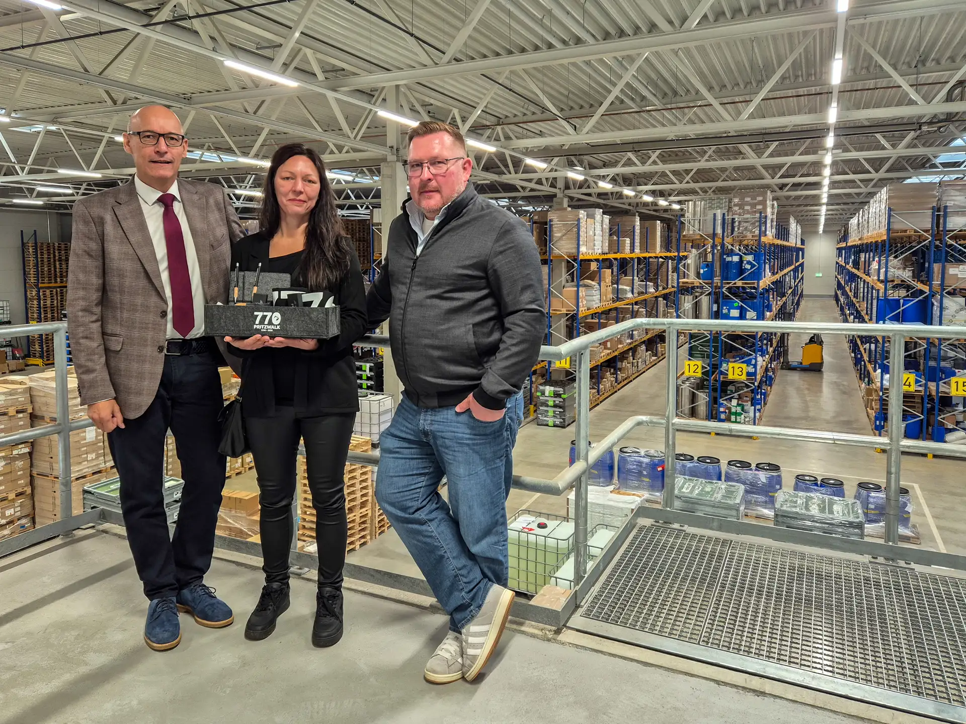 Bürgermeister Dr. Ronald Thiel, Geschäftsführerin Na- dine Behrens und Inhaber Robert Schulze in der Promix-Lagerhalle in Fal- kenhagen.